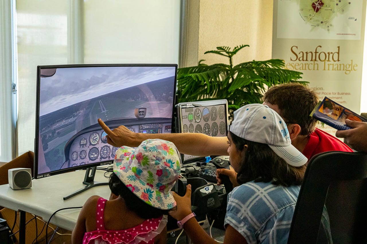 Kids enjoying flight simulation at an EAA Event