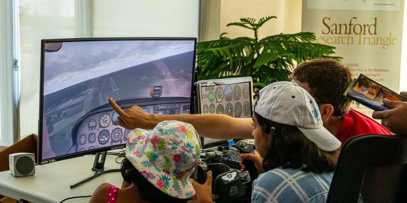 Kids enjoying flight simulation at an EAA Event